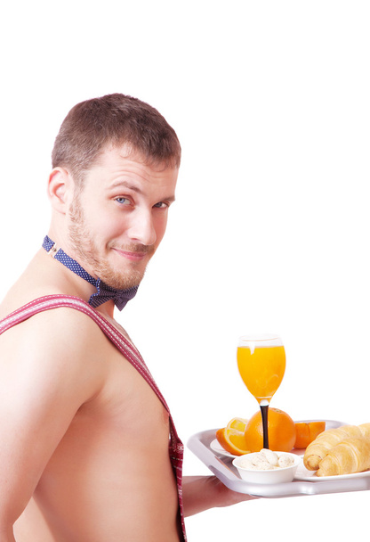 Funny man in an apron with breakfast - 写真・画像