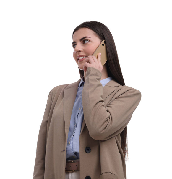 Beautiful businesswoman talking on smartphone against white background - Fotó, kép