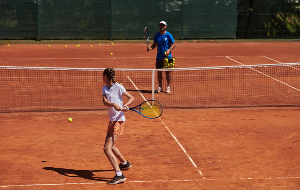 A professional tennis player and her coach training on a sunny day at the tennis court. Training and preparation of a professional tennis player. - Φωτογραφία, εικόνα