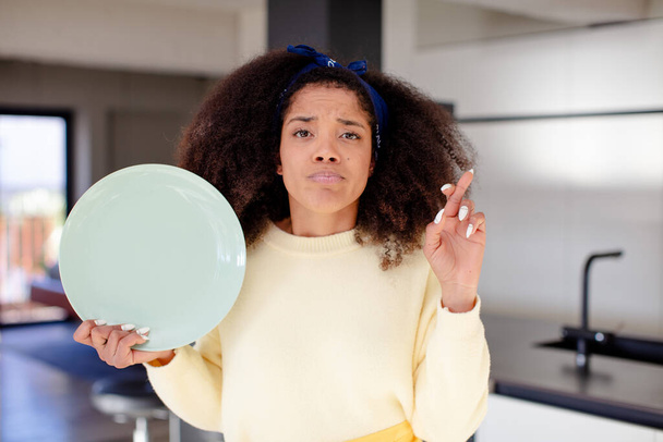 pretty afro black woman crossing fingers and hoping for good luck. home chef concept - Photo, Image