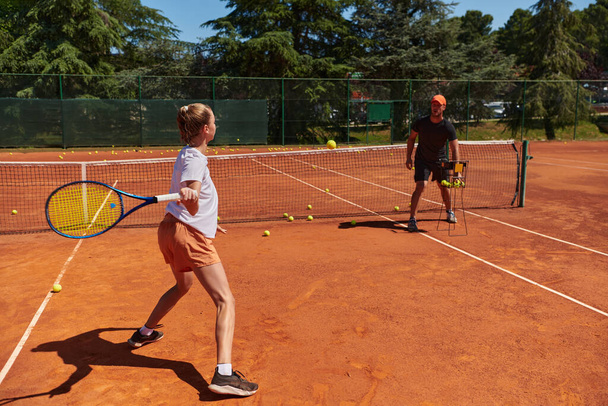 A professional tennis player and her coach training on a sunny day at the tennis court. Training and preparation of a professional tennis player. - Φωτογραφία, εικόνα