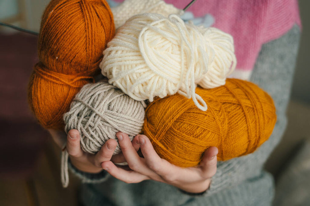 Close-up view of womans hands holding ball of yarn threads in her hands. Domestic lifestyle. Lifestyle concept. - Photo, Image