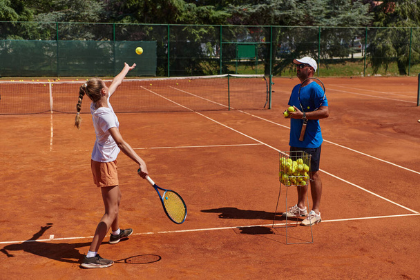 A professional tennis player and her coach training on a sunny day at the tennis court. Training and preparation of a professional tennis player. - Fotoğraf, Görsel