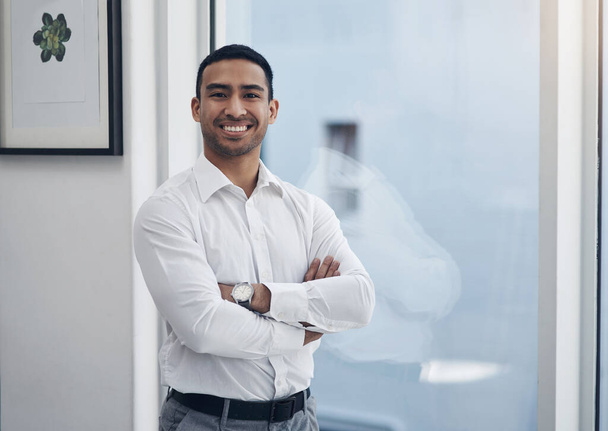 Portrait, business and man with arms crossed, window and employee with confidence, startup success and career. Male person, happy agent or entrepreneur in a modern office, professional and happiness. - Foto, Imagem