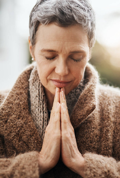 Starsza kobieta modli się, ręce z kultem i religią, Bóg z pokojem, wdzięcznością i wiarą na zewnątrz. Duchowa kobieta w naturze z zamkniętymi oczami i modlitwą o przewodnictwo i błogosławieństwo. - Zdjęcie, obraz