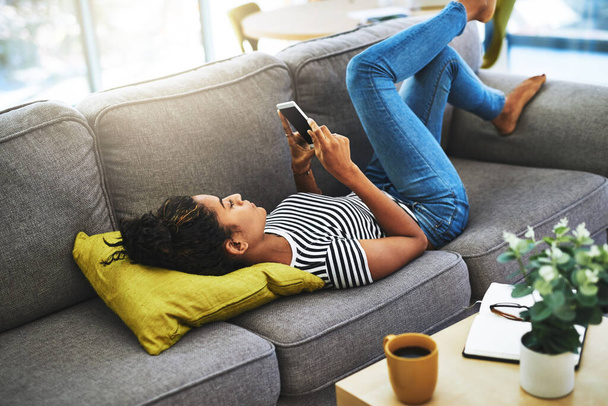 Relax, phone and woman on sofa in home for network, online website and social media. Communication, mobile app and happy female person on smartphone for chatting, text message and internet connection. - Фото, зображення
