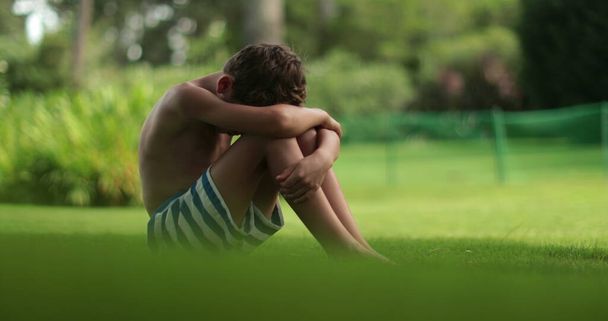 Surullinen järkyttynyt lapsi poika pää alas ulkona puistossa - Valokuva, kuva
