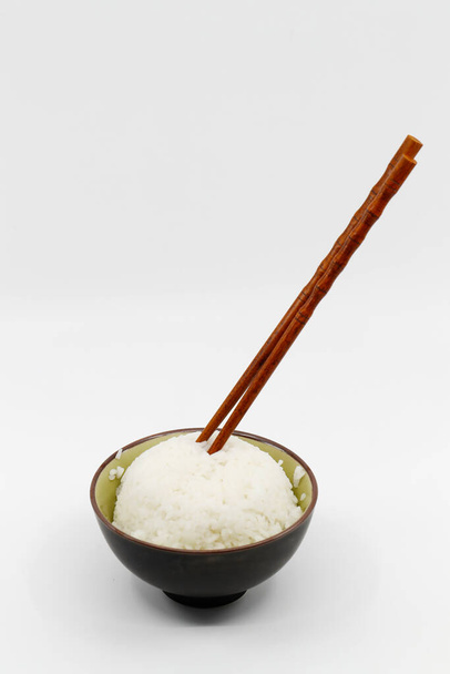 Asian food. White rice and chopsticks. - Photo, Image