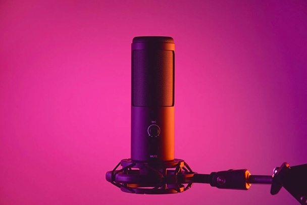 Studio condenser microphone isolated on dark background. The concept of vocals, streaming, podcast. - Foto, Imagem
