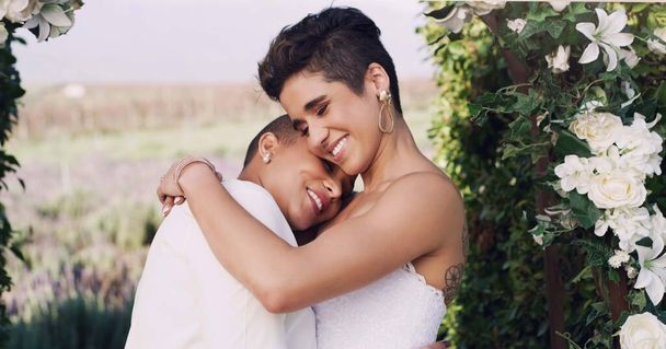 Love, hug and lgbtq with lesbian couple at wedding for celebration, gay and pride. Smile, spring and happiness with women at marriage event for partner commitment, sexuality and freedom. - Foto, immagini