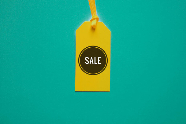sale word on the yellow price tag for sales  - Photo, Image