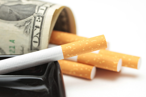 cigarettes and money. expensive habit. white background - horizontal photo. - Фото, зображення