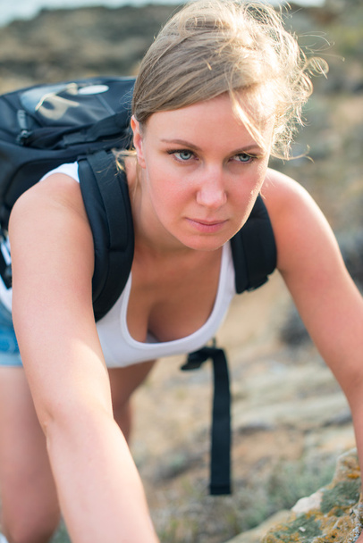 Pretty woman with backpack hiking in the mountains. - Photo, Image