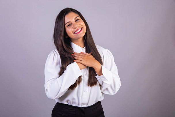 Brazilian businesswoman, manager, corporate portrait. hands on chest gratitude. - Photo, Image