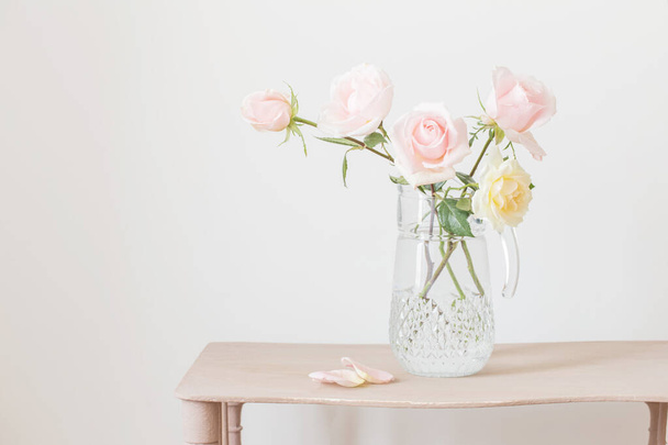 beautiful roses in glass jug on white background - Φωτογραφία, εικόνα