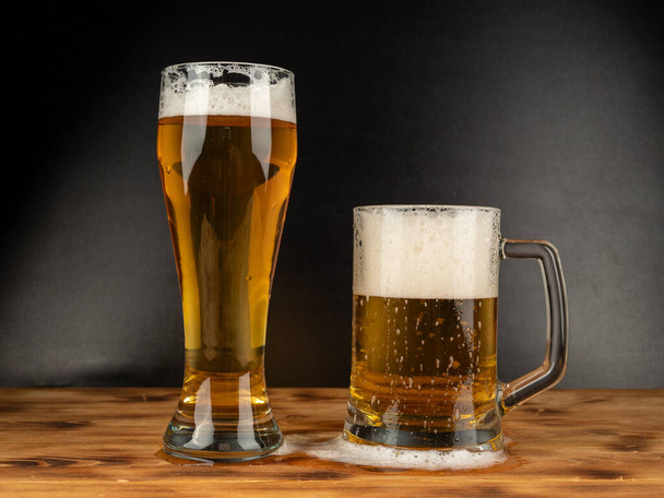 A glass of cold beer on a dark background. Glass of beer close-up. - Photo, Image