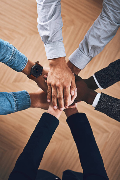 Teamwork, partnership or hands of business people in support for faith, vision or strategy in office. Above, diversity or employees in group collaboration with hope or mission for goals together. - Photo, Image