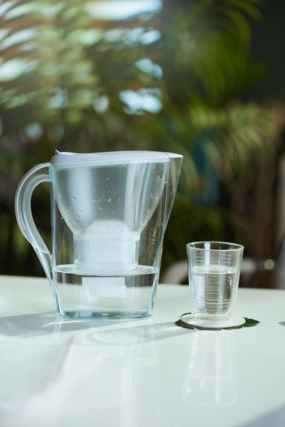 water filter and cup on the table in the modern office. - Valokuva, kuva