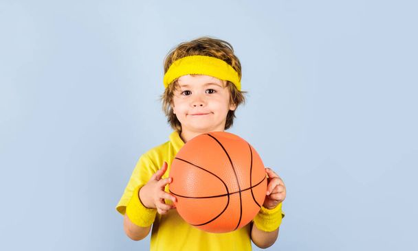 Sportsman child with basketball ball. Sport equipment. Cute boy playing basketball. Professional sport. Little basketballer with basketball. Sport lifestyle. Basketball training game. Kid activities - Foto, afbeelding