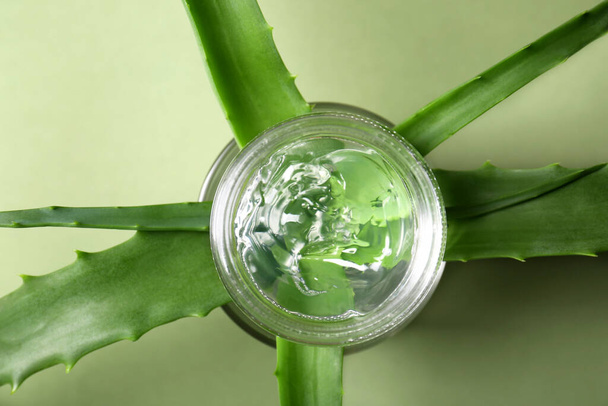 Aloe leaves and cosmetic gel on olive background, flat lay - Fotografie, Obrázek