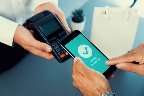 Hand holding smartphone with NFC QR code device, scanning contactless payment code for fast digital transaction. Online banking app on mobile phone for modern lifestyle payment technology. fervent - Photo, image