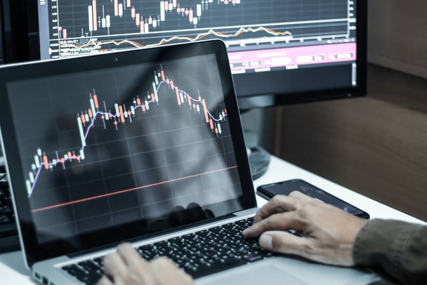 Businessman working on trading stock market with laptop with stock graph background. - Zdjęcie, obraz