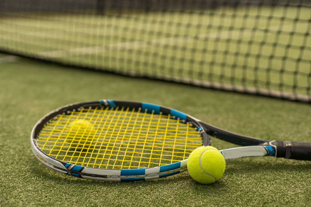 tennis racket with a tennis ball on a tennis court. - Fotó, kép