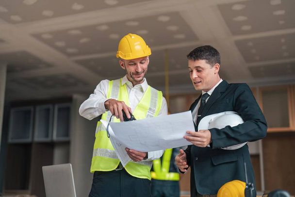 Professional construction engineers team using blueprint of project plan brainstorming and working together at construction building, Architecture and building construction concept. - Foto, Imagen
