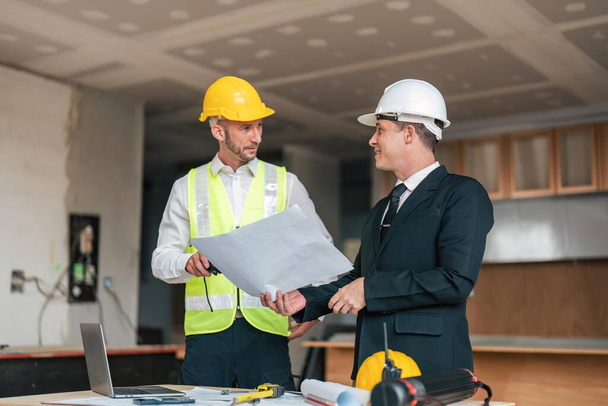 Professional construction engineers team using blueprint of project plan brainstorming and working together at construction building, Architecture and building construction concept. - Fotoğraf, Görsel