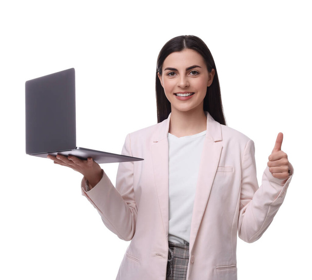 Beautiful happy businesswoman with laptop showing thumbs up on white background - Фото, зображення
