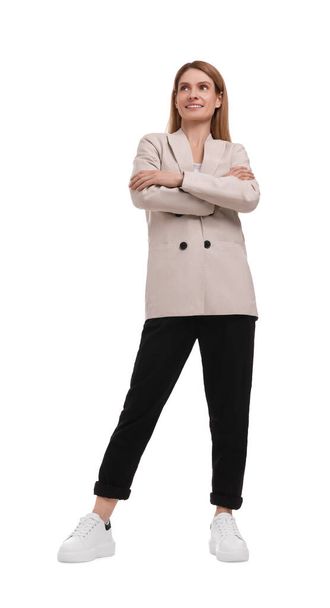 Beautiful happy businesswoman crossing arms on white background - Фото, изображение