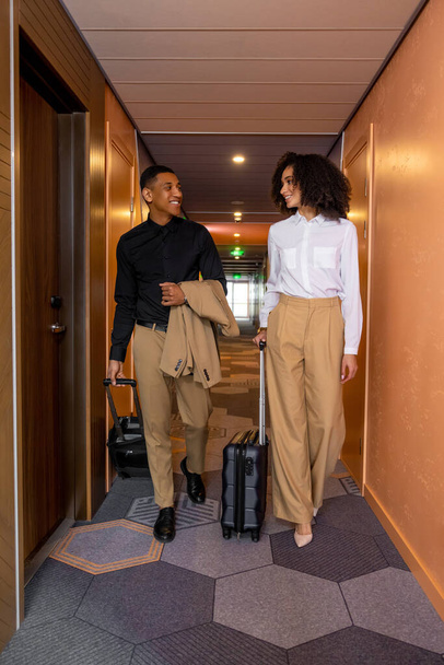 Arrival. Two young well-dressed people going to their rooms in the hotel - Φωτογραφία, εικόνα