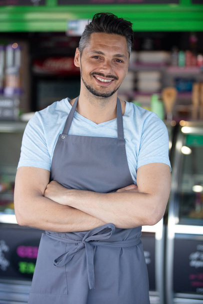 portrait of male worker outside his ice-cream parlour - Фото, изображение