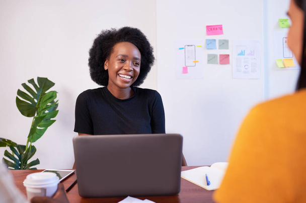 Black woman with afro smiles at meeting, development team coding, laptop. High quality photo - Fotoğraf, Görsel
