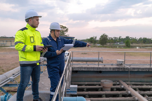 Environmental engineers work at wastewater treatment plants,Water supply engineering working at Water recycling plant for reuse,Technicians and engineers discuss work together. - Photo, Image