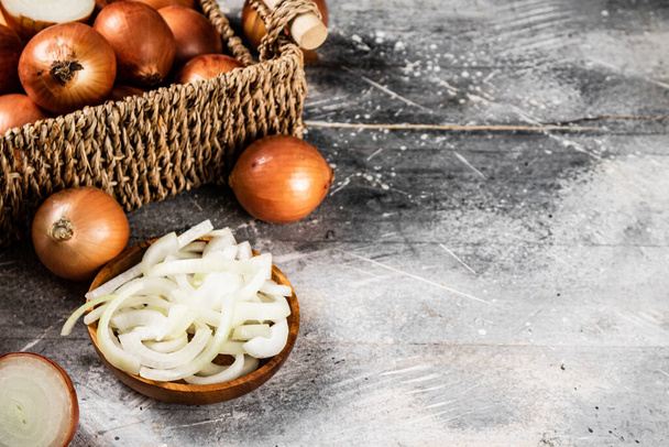 Chopped onions in a plate and whole in a box. On a gray background. High quality photo - Fotoğraf, Görsel