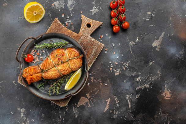 delicious salmon steak with spices and herbs on a dark background, banner, menu, recipe place for text, top view, - Foto, Bild