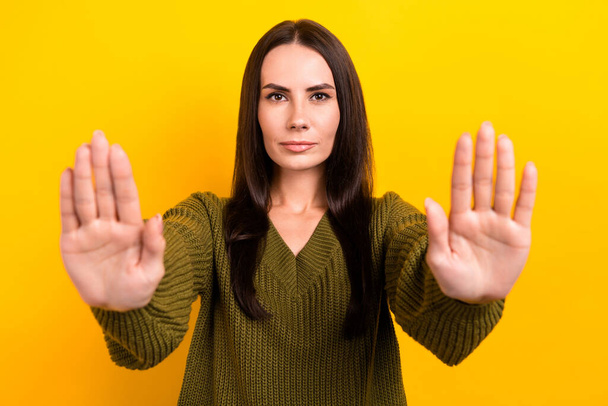 Portrait of calm focused lady arms palms demonstrate stop enough symbol you isolated on yellow color background. - Foto, immagini