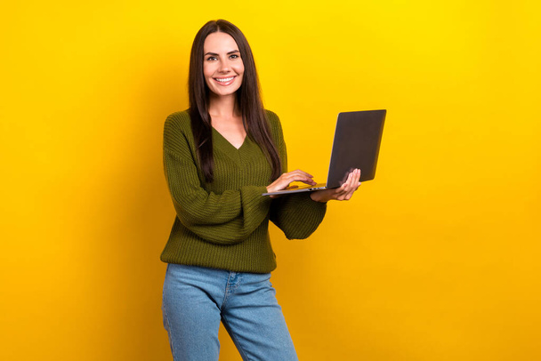 Photo of cheerful positive lady wear khaki pullover smiling texting instagram twitter telegram facebook isolated yellow color background. - Fotografie, Obrázek