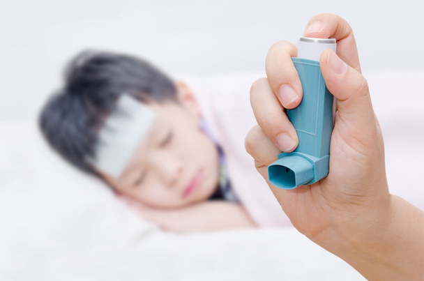 Mother holding asthma inhaler - Photo, Image