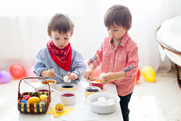 Two boys, coloring eggs for Easter - Fotó, kép