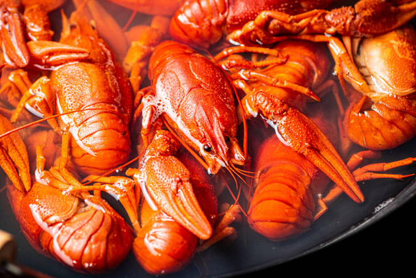 Crayfish are boiled in a pot in water. Macro background. High quality photo - Фото, изображение