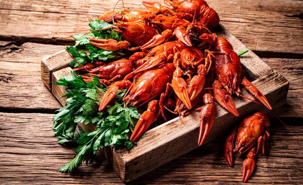 Fragrant boiled crayfish on the table. On a wooden background. High quality photo - Foto, Bild