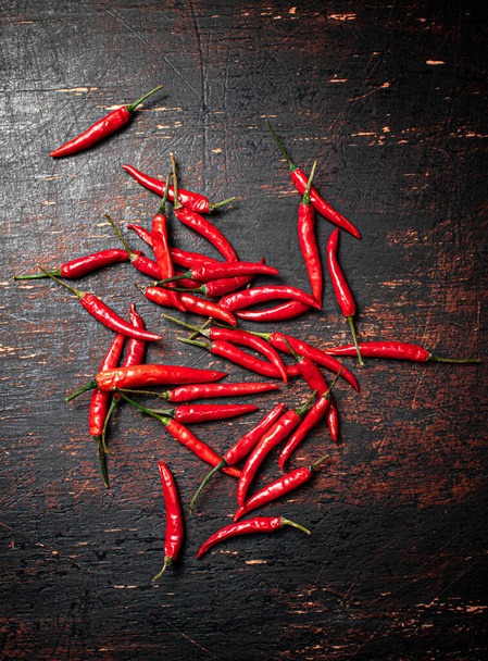 A bunch of hot chili pepper pods. Against a dark background. High quality photo - Foto, Imagem