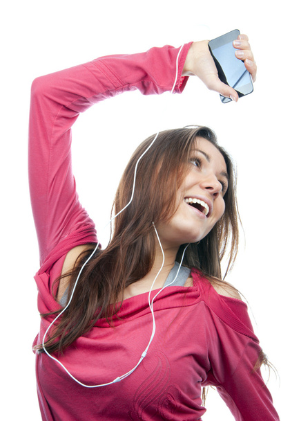 Girl listening, enjoying music and holding cellular mp3 player - Fotoğraf, Görsel