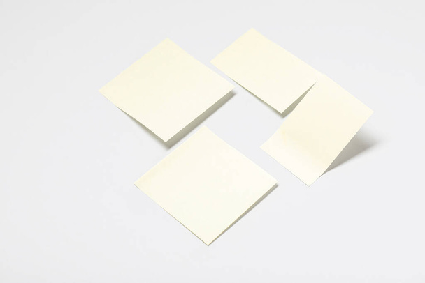 Pale yellow sticky notes on grey background - Фото, изображение