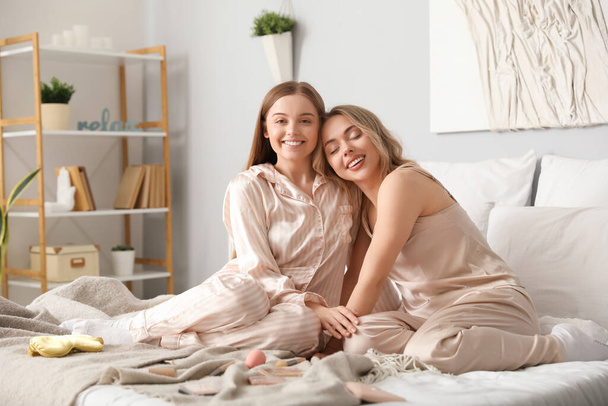 Young sisters hugging in bedroom - Photo, Image