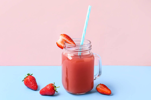Mason jar of tasty strawberry juice on blue table - Fotografie, Obrázek