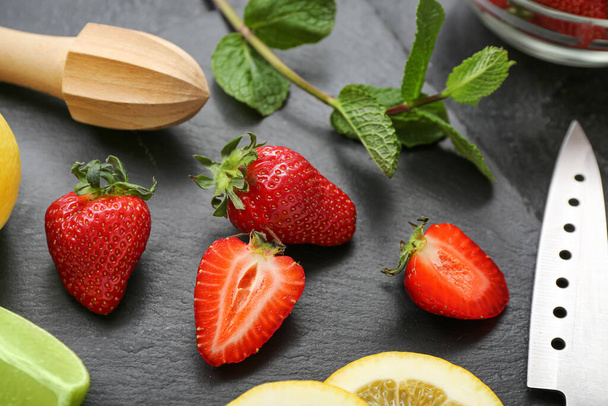 Ripe strawberry, lime, lemon and mint on dark background, closeup - Fotografie, Obrázek