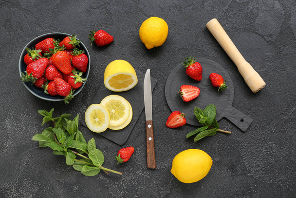 Composition with ripe strawberry, lemon and mint on dark background - Foto, imagen